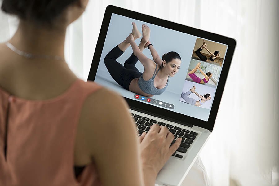 a woman watching a yoga video a woman watching a yoga video